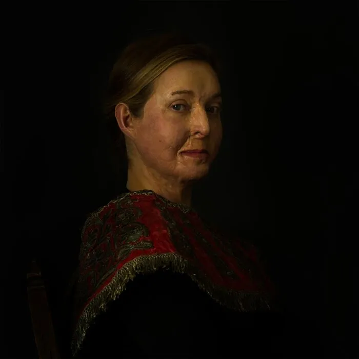 Portrait of woman with facial scars in dark setting, best pics Siena International Photo Awards 2026