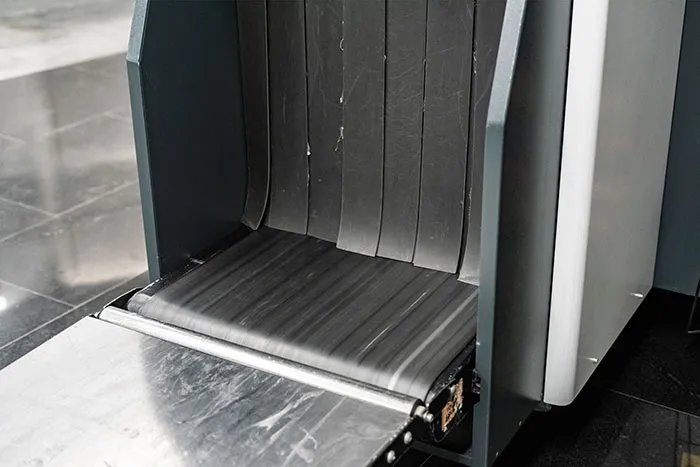 Airport baggage scanner conveyor belt where TSA agents screen travelers luggage