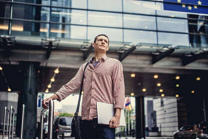 A worried traveler standing outside an airport terminal, representing travelers stopped by TSA