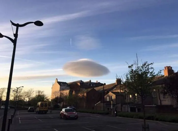 Unusual lenticular cloud over a town glitch in the matrix