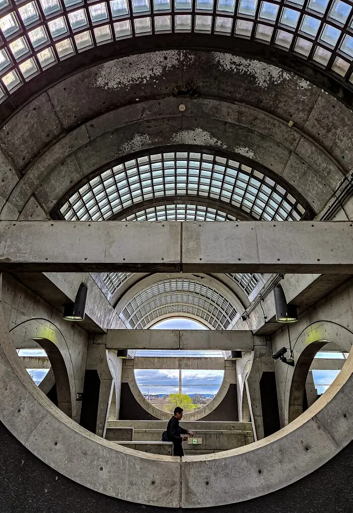 A person walking through a concrete tunnel with geometric patterns, featured in The Perspa Awards 2026.