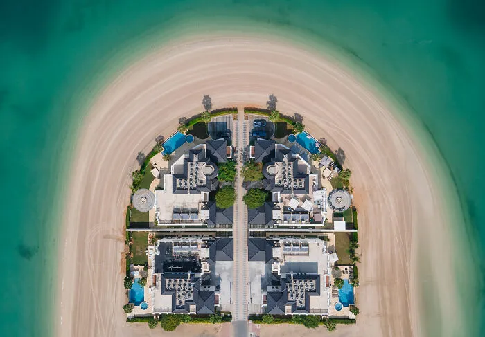 Aerial view showing the hidden beauty of buildings and spaces on a sandy crescent