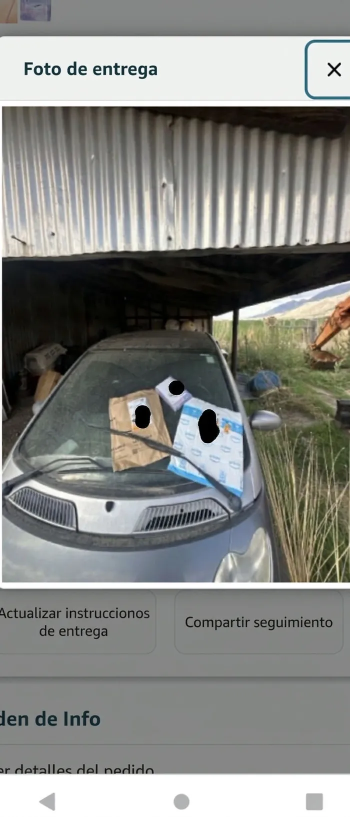 Paquetes entregados sobre el parabrisas de un auto por repartidores.